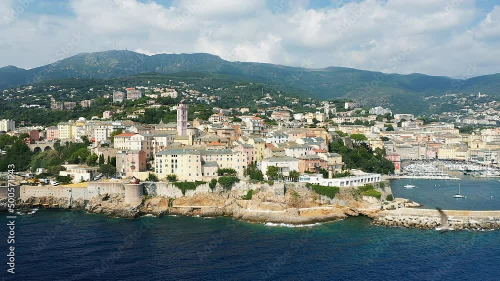 The city of Bastia and its port at the foot of the mountains, in Europe, in France, in Corsica, by the Mediterranean Sea, in summer, on a sunny day. The city of Bastia and its port at the foot of the mountains, in Europe, in France, in Corsica, by the Mediterranean Sea, in summer, on a sunny day.