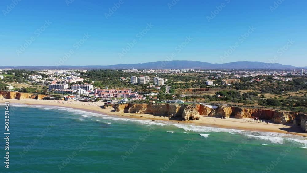 The city of Albufeira on the edge of the cliffs and the Ocean , in Europe, in Portugal, in the Algarve, in summer, on a sunny day. The city of Albufeira on the edge of the cliffs and the Ocean , in Europe, in Portugal, in the Algarve, in summer, on a sunny day.