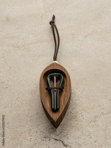 Jew's harp in a wooden case, beige background