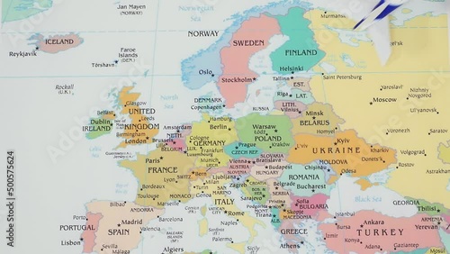 Toy plane travels over different countries on a map of Europe. Concept of international flights, tourism. Stop motion animation.