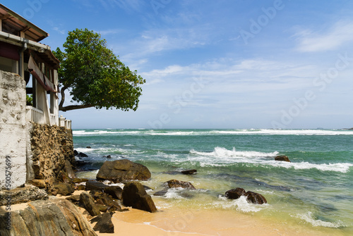 Rocky tropical beach with house  rural Sri Lanka