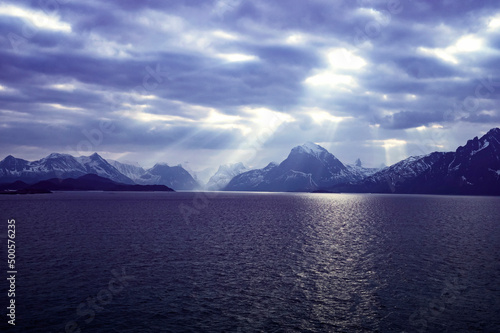 Dark moody sky with light rays over the coast of Norway