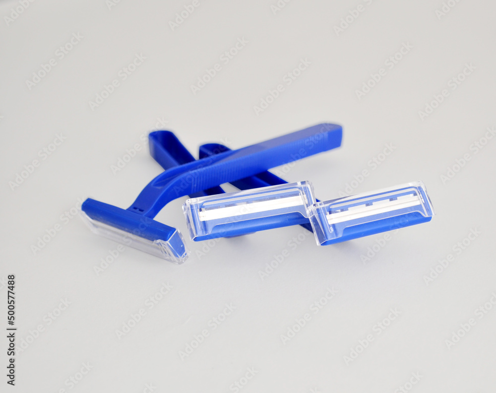 disposable blue shaving razor on light background disposable blue shaving razor on light background