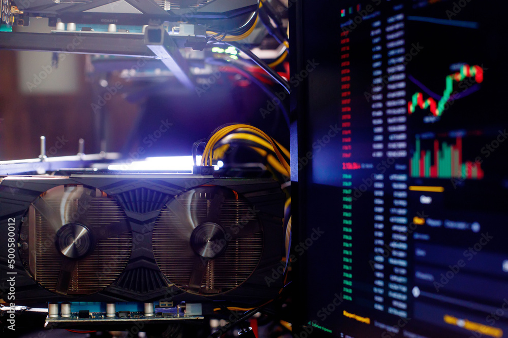 Graphics cards in rig for ethereum mining farm on background Stock Market ETH Chart