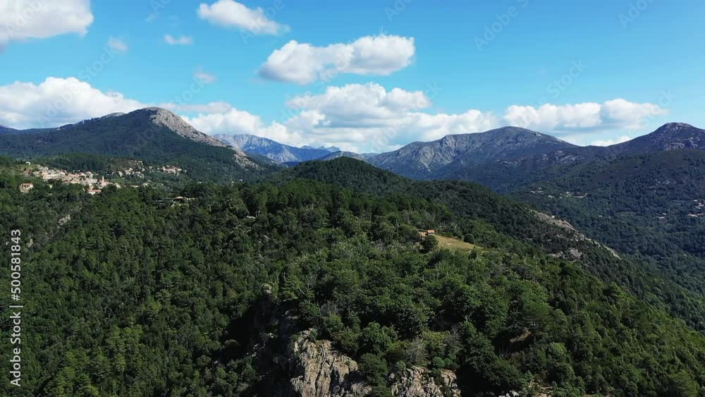 The arid countryside among mountains and green forests , in Europe, France, Corsica, towards Ajaccio, by the Mediterranean sea, in summer, on a sunny day. The arid countryside among mountains and green forests , in Europe, France, Corsica, towards Ajaccio, by the Mediterranean sea, in summer, on a sunny day.