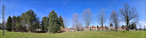 Panoramic web banner of the public park in a residential district. Tranquillity scene of a panoramic view of the park in spring.