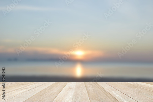 Empty top wooden table on soft focus blurred sea beach for background