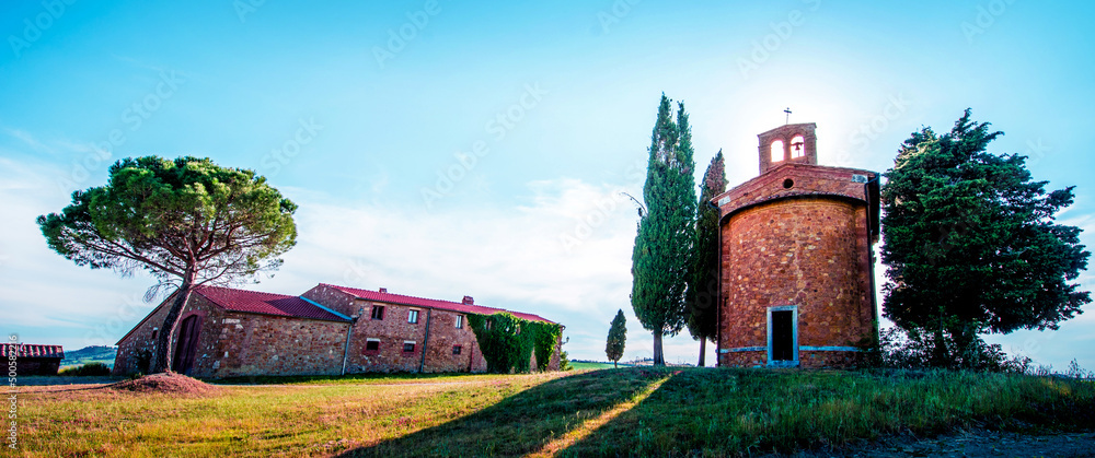 Tuscany, Italy, May, 2017: Magic landscape with chapel of Madonna di Vitaleta on a sunny day in San Quirico d'Orcia (Val d'Orcia) in Tuscany, Italy. Excellent tourist places.