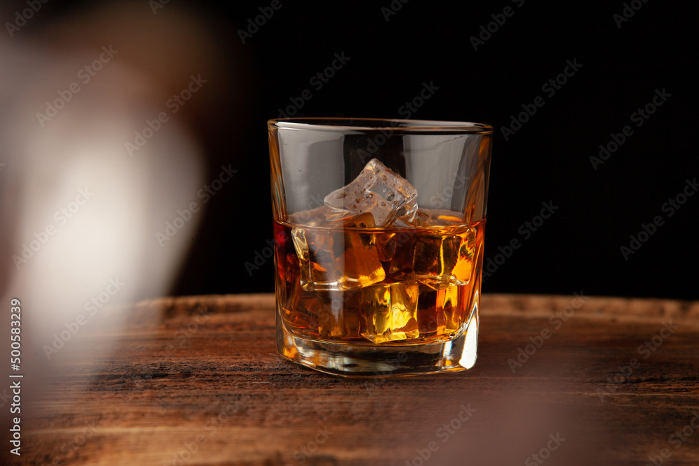 Whiskey or alcoholic beverages or bourbon with ice on the wooden floor and a black and white scene with a top view Whiskey or alcoholic beverages or bourbon with ice on the wooden floor and a black and white scene with a top view