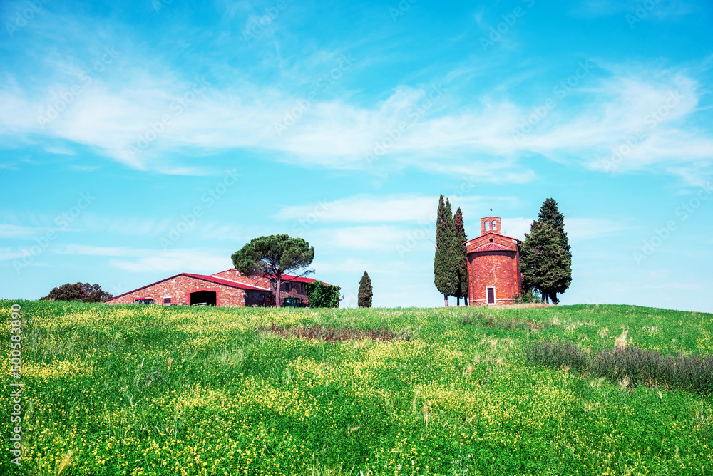 Tuscany, Italy, May, 2017: Magic landscape with chapel of Madonna di Vitaleta on a sunny day in San Quirico d'Orcia (Val d'Orcia) in Tuscany, Italy. Excellent tourist places.