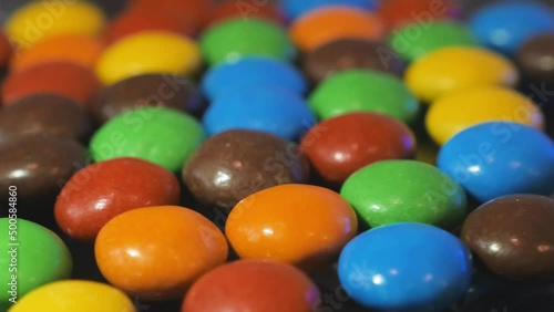 Macro video of a heap of multi-colored dragees and sweets