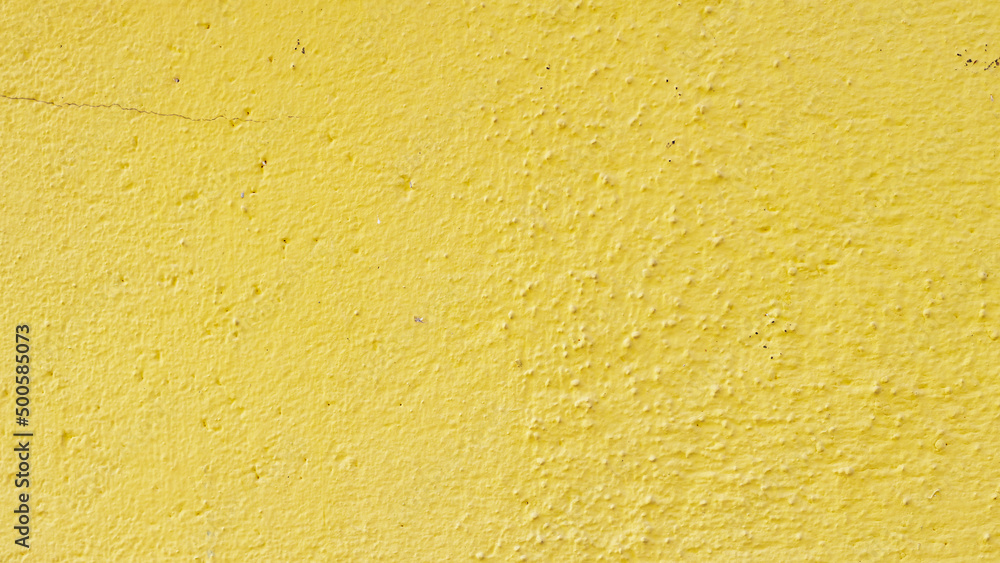 Yellow painted cement surface. Texture of old wall covered with yellow stucco. Grunge color painted background Yellow painted cement surface. Texture of old wall covered with yellow stucco. Grunge color painted background