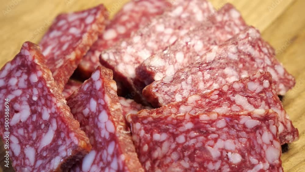 Pieces of smoked sausage on a rotating surface. Pieces of smoked sausage on a rotating surface.