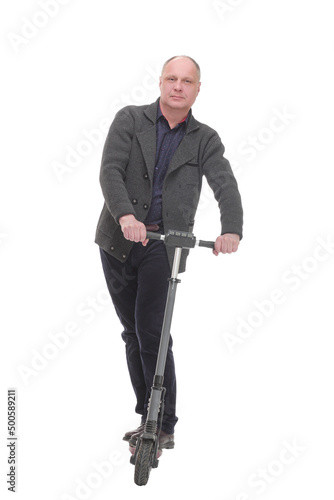 happy casual man with electric scooter .isolated on a white background. © ASDF