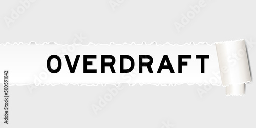 Ripped gray paper background that have word overdraft under torn part