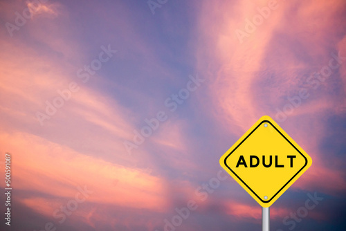 Yellow transportation sign with word adult on violet color sky background