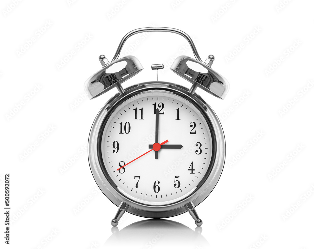 Alarm clock isolated on white background. Three hours after midnight or noon. Fifteen hours on the clock. Alarm clock isolated on white background. Three hours after midnight or noon. Fifteen hours on the clock.