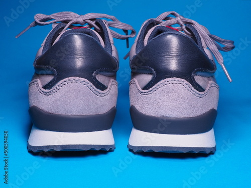 Classic sports shoes on a blue background. Leg comfort and convenience. Active and sporty lifestyle