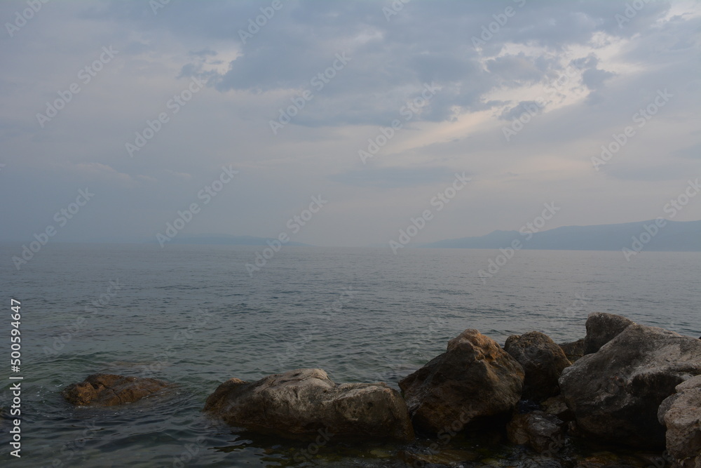 View of the sea with sunset and rocks