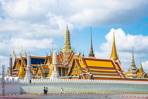 Photography Wat Phra Kaew Temple of the Emerald Buddha, grand palace on the cloudy blue sky day, the most famous spot and must visit place and temple in Bangkok, Thailand including unidentified mask tourist