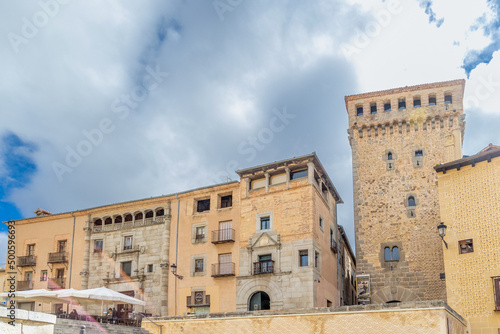 views of the streetsr of Segovia with tourists walking under streets in Segovia