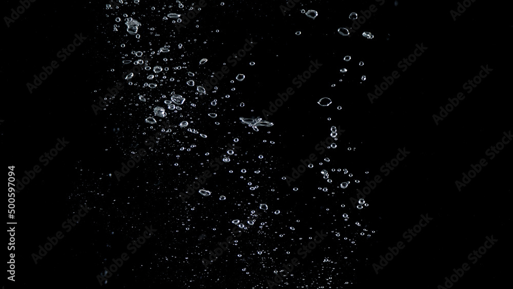 Close-up images of soda water splashing in the water to many little bubbles that make it feel like refreshing and black background 