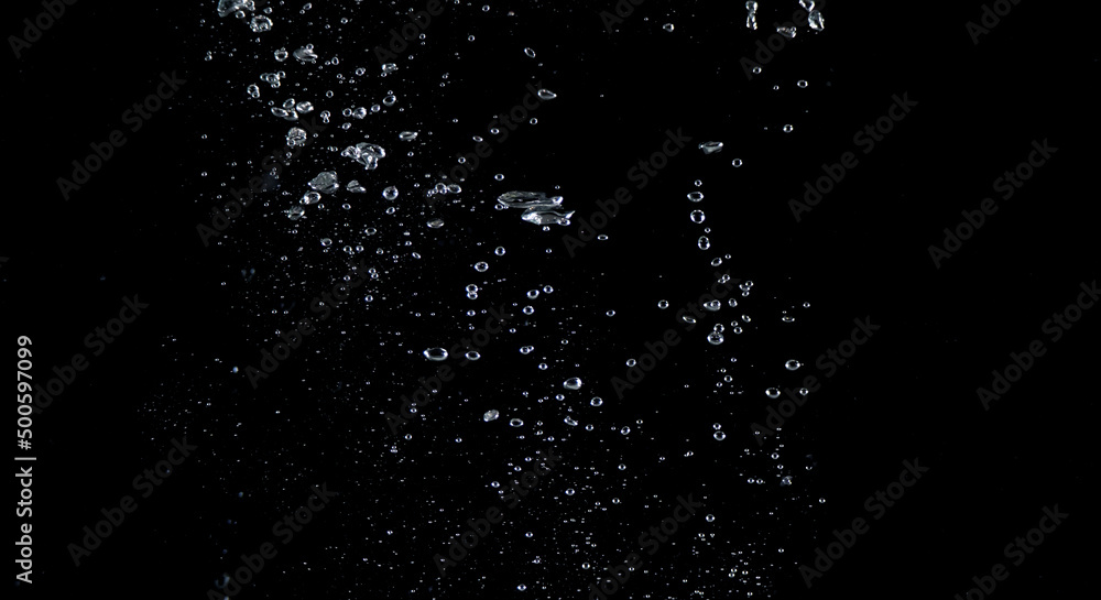 Close-up images of soda water splashing in the water to many little bubbles that make it feel like refreshing and black background Close-up images of soda water splashing in the water to many little bubbles that make it feel like refreshing and black background