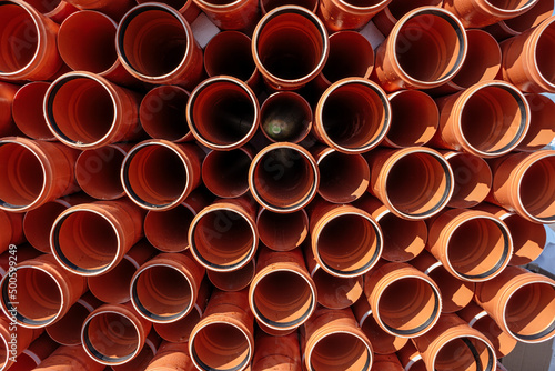 Stack of Orange pipe made of polyvinyl chloride