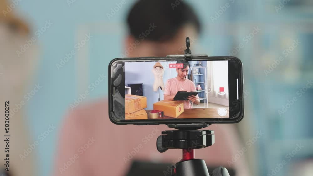 Asian men sell products online using mobile phone live broadcasting products through social media Asian men sell products online using mobile phone live broadcasting products through social media