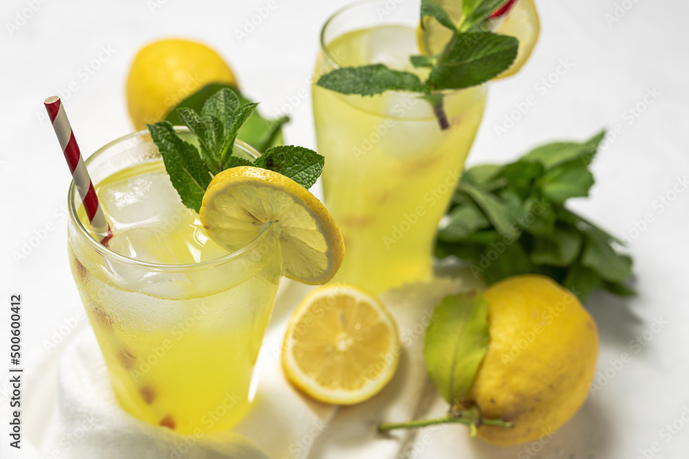 Fresh Lemonade or mojito cocktail with lemon, mint and ice Fresh Lemonade or mojito cocktail with lemon, mint and ice