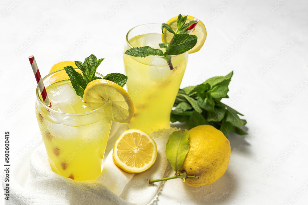 Fototapeta premium Fresh Lemonade or mojito cocktail with lemon, mint and ice