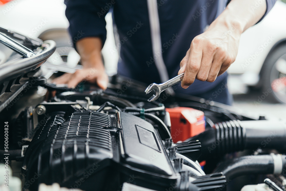 Automobile mechanic repairman hands repairing a car engine automotive workshop with a wrench, car service and maintenance,Repair service.