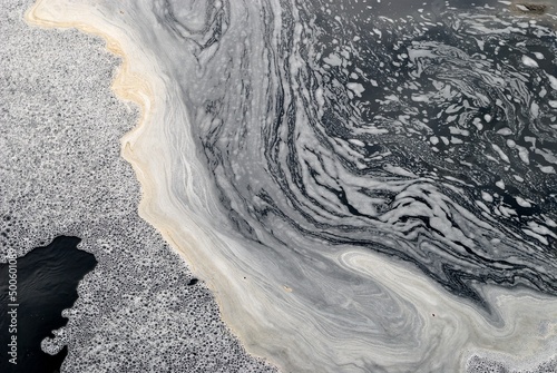 Spring flood of the river, foam on the water.