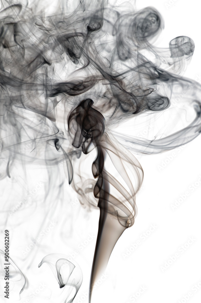 Puffs and curls of dark smoke on a white background rising from a burning stick Puffs and curls of dark smoke on a white background rising from a burning stick