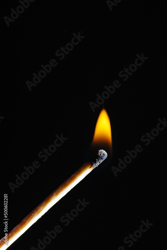 Wooden match, lights up, burns and goes out, on a black background