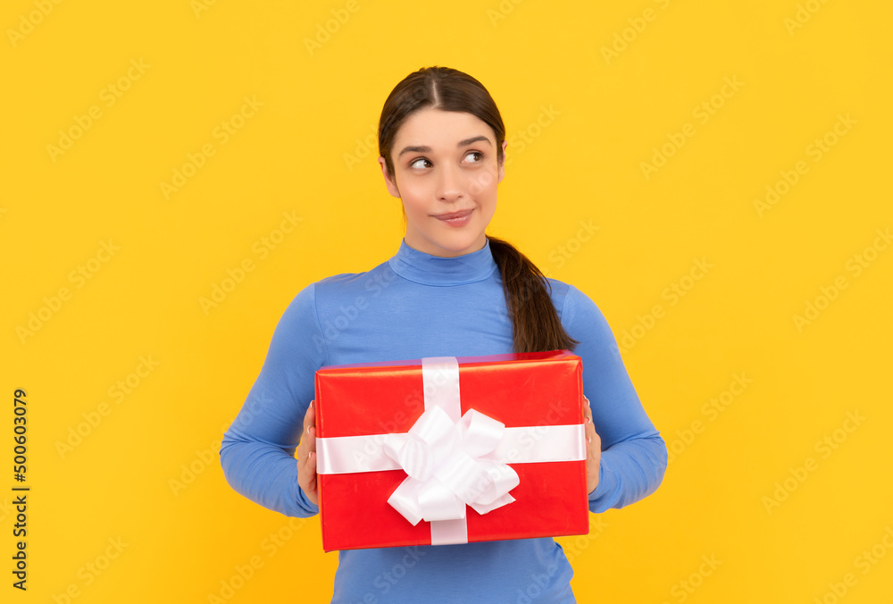 black friday discount. seasonal sales. dreamy girl with box on yellow background. boxing day. black friday discount. seasonal sales. dreamy girl with box on yellow background. boxing day.