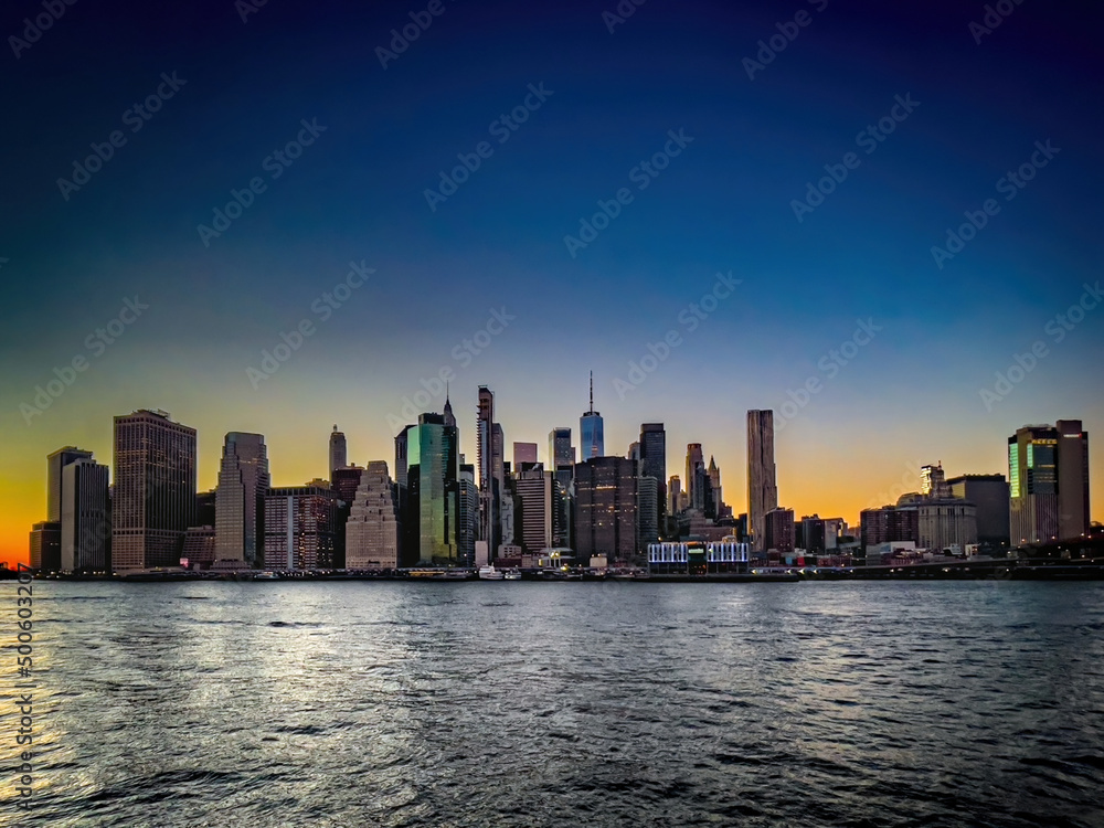Panoramic view of beautiful sunset and colorful sky with Manhattan skyline in New York City.