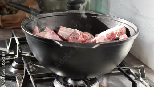 Chopped onions and pieces of meat are fried in boiling oil. Cooking pilaf in a cauldron, a step-by-step recipe for real pilaf.