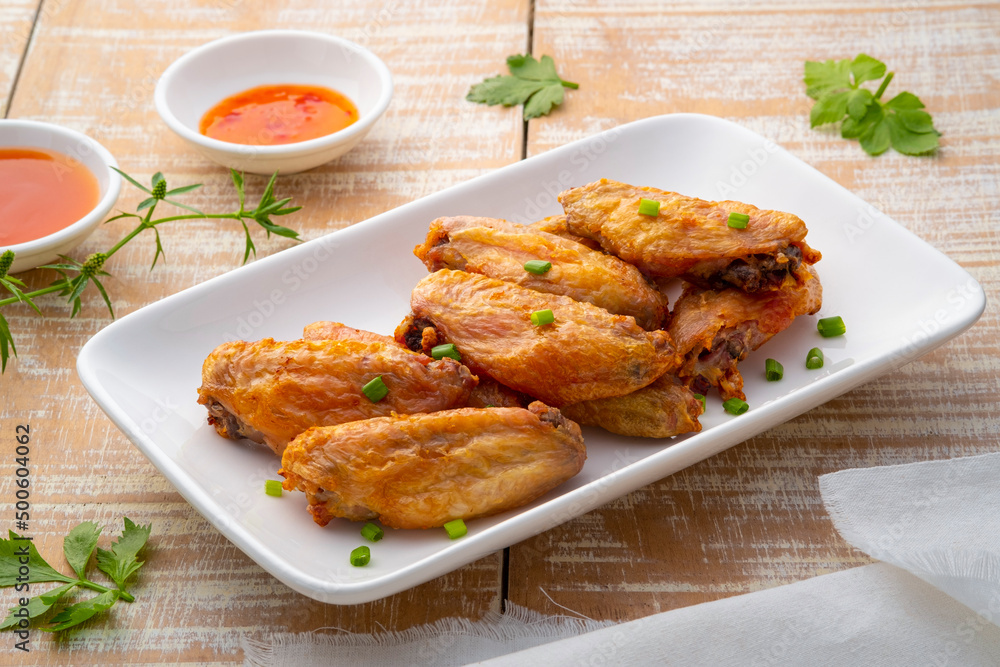 Air Fryer Chicken middle wing stick (wingette) with Fish Sauce on white plate Air Fryer Chicken middle wing stick (wingette) with Fish Sauce on white plate