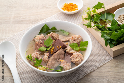 Pork blood curd soup with gourd leaves,Clear soup asian style food mixed minced pork balls,Pork blood cubes and liver in with bowl,Healthy and Rich in iron and protein