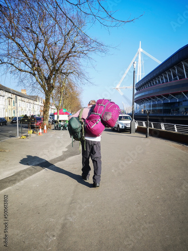 Unidentified homeless man carrys his bags along a street near the Principality Stadium in Cardiff.