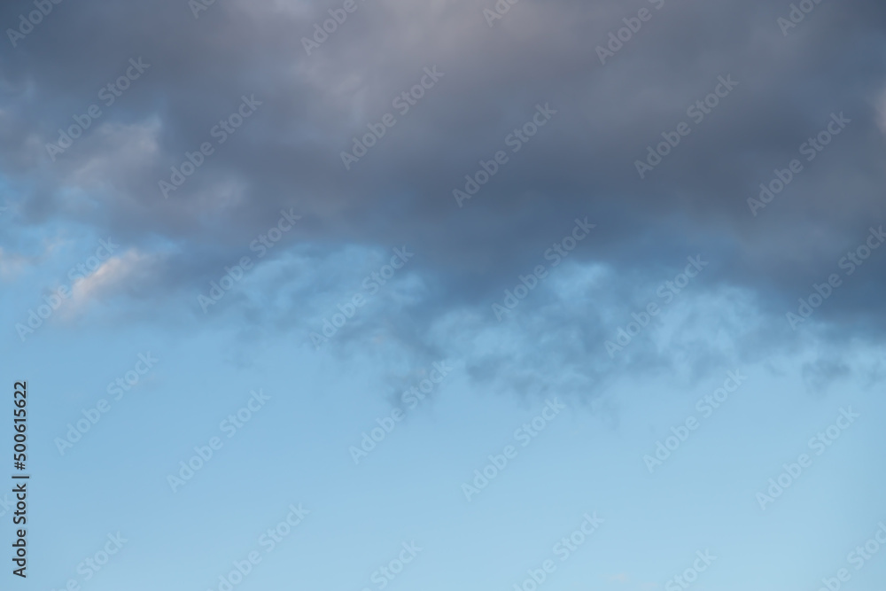 Fototapeta premium White cumulus clouds on a clear blue sky.