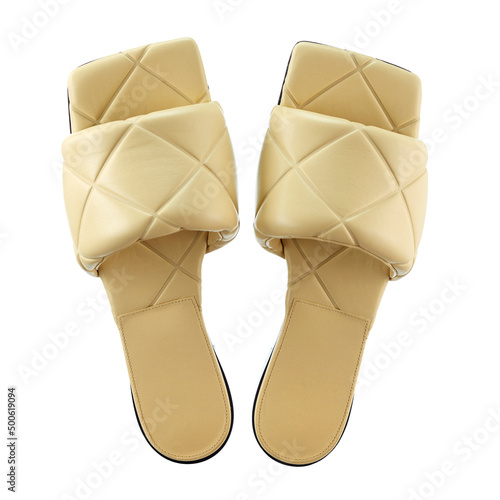 Beautiful pair of women's cream-colored genuine leather flip-flops embossed in the form of squares, on a thin sole, highlighted on a white background. Top view. The trend of the season.