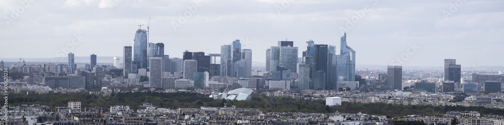 Paris, France, Europe: aerial view of the city skyline with the skyscrapers of the La Defense, a business district with offices, condos and shopping centers, seen from the top of the Eiffel Tower