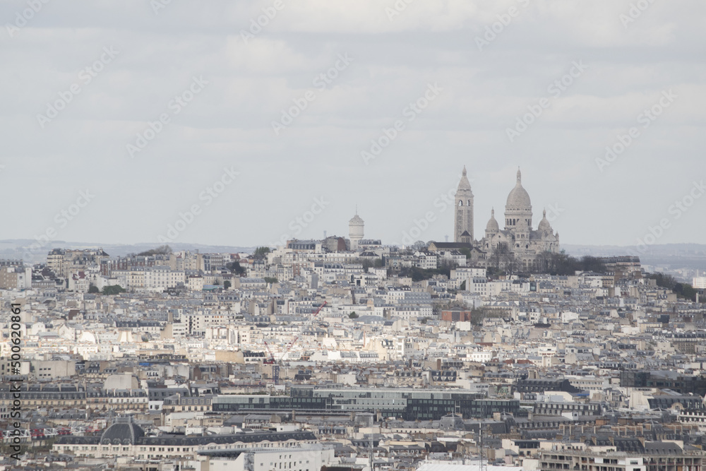Paris, France, Europe: aerial view from the top of the Eiffel Tower with Montmartre hill, the highest point in the city, and Basilica of the Sacred Heart, Roman Catholic church completed in 1914
