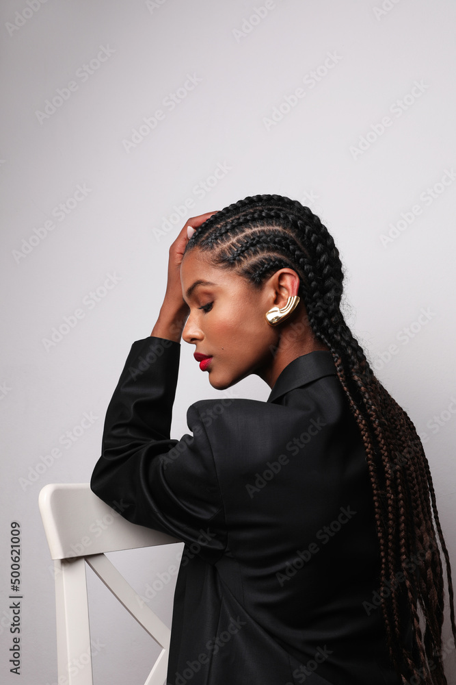 Vertical side portrait of African young woman with long braids wears ...