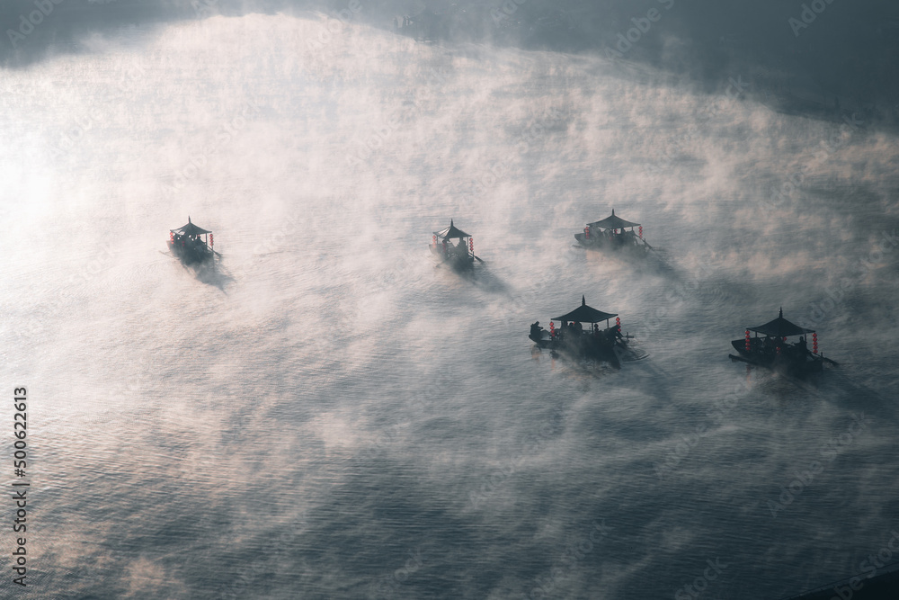 Fototapeta premium Sunrise with fog over Ban Rak thai, chinese village near a lake in Mae Hong Son, Thailand