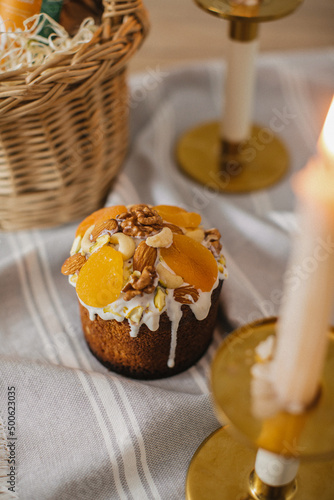 Delicious Easter cakes and eggs on white table with flowers  © Olya