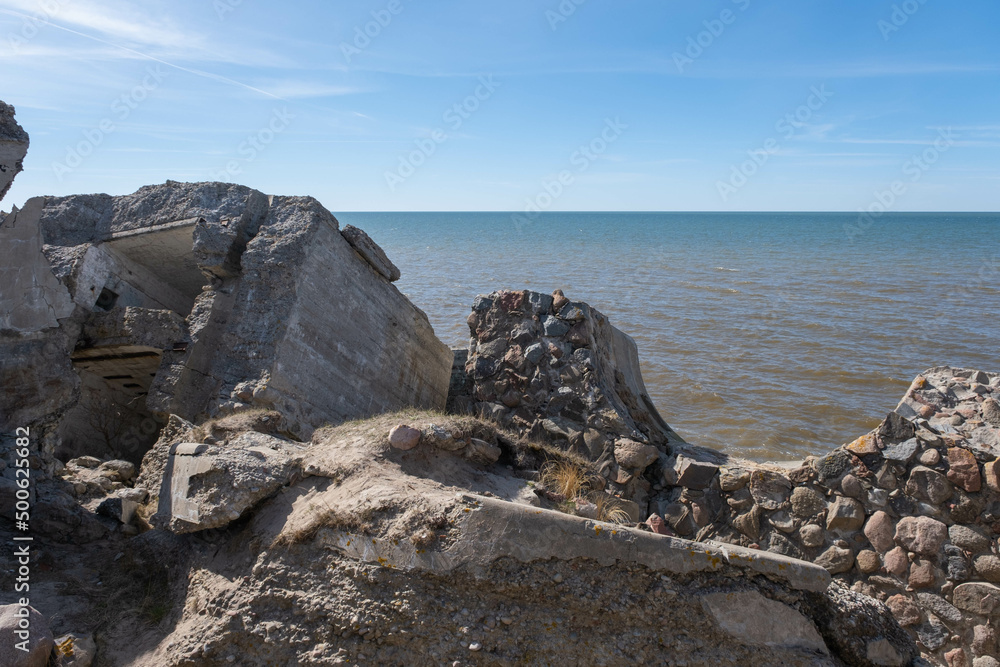 Ruins of bunkers on the beach of the Baltic sea, part of an old fort in the former Soviet base Karosta in Liepaja, Latvia