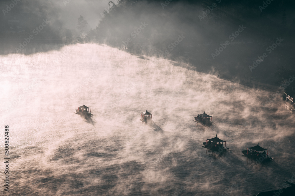 Fototapeta premium Sunrise with fog over Ban Rak thai, chinese village near a lake in Mae Hong Son, Thailand